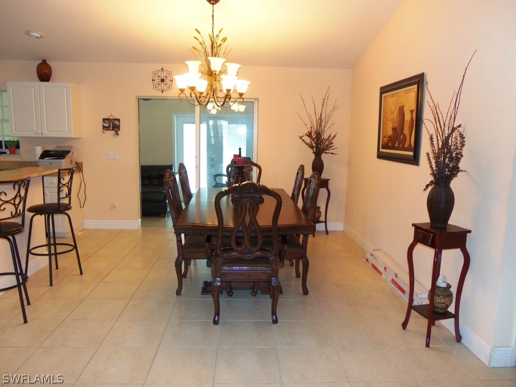 462 Rajah Street Lehigh Acres, FL 33974 - Photo 3 of 17 a view of a dining room with furniture and chandelier