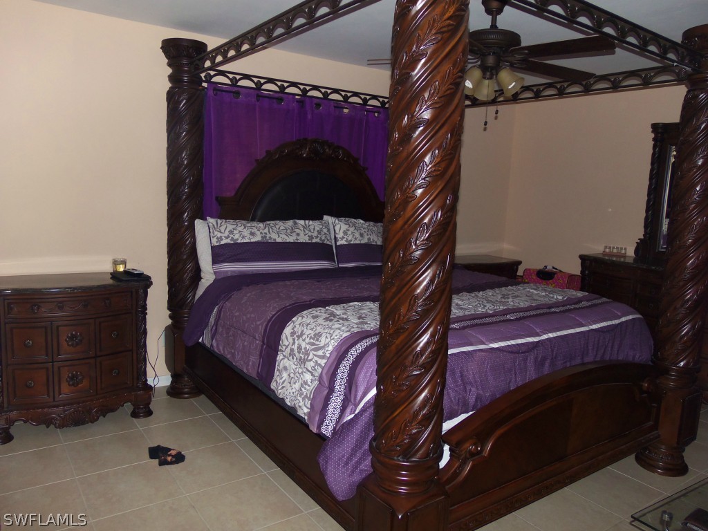 462 Rajah Street Lehigh Acres, FL 33974 - Photo 7 of 17 a bed sitting in a bedroom next to a dresser