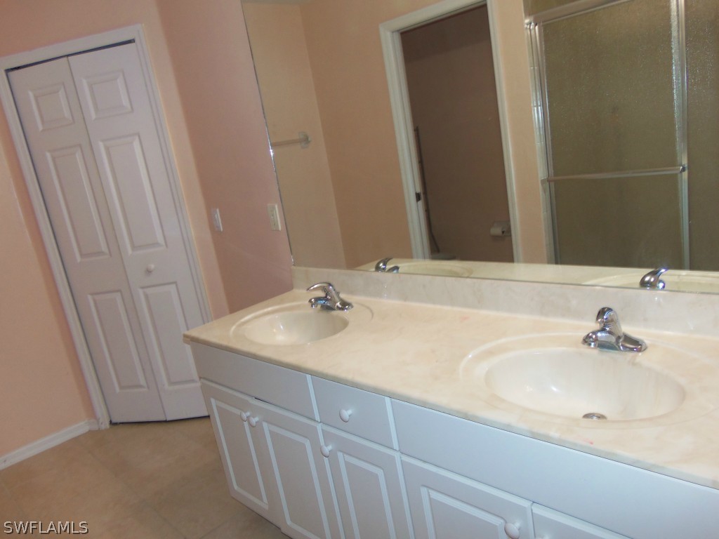 462 Rajah Street Lehigh Acres, FL 33974 - Photo 9 of 17 a bathroom with a sink and a mirror