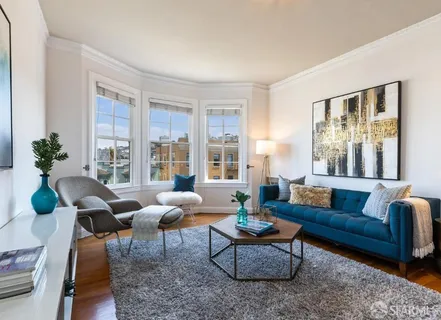 a living room with furniture and floor to ceiling windows