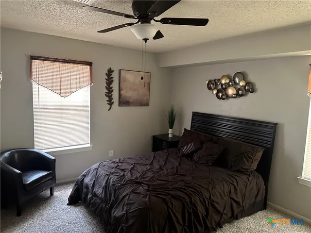 a bed sitting in a bedroom next to a window