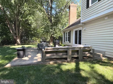 a view of a house with a backyard and a patio