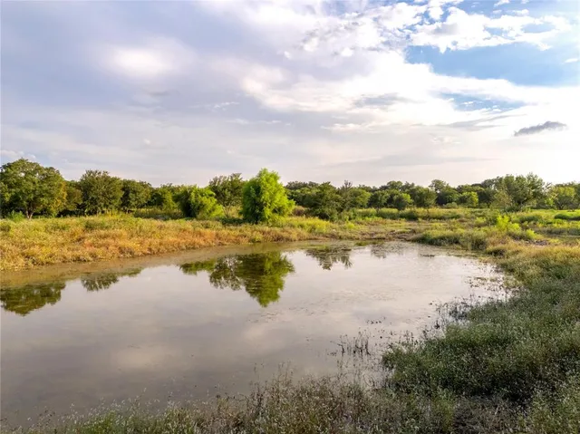 a view of a lake with houses in the back