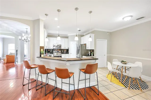 a large kitchen with a table and chairs