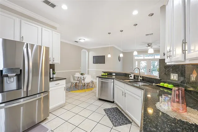 a kitchen with lots of counter top space appliances and cabinets