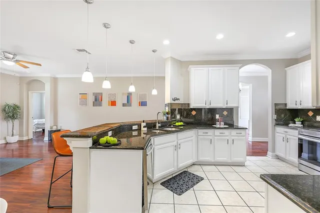a kitchen with white cabinets a table and chairs