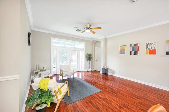 a living room with furniture and wooden floor
