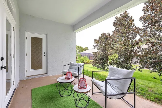 a balcony with table and chairs