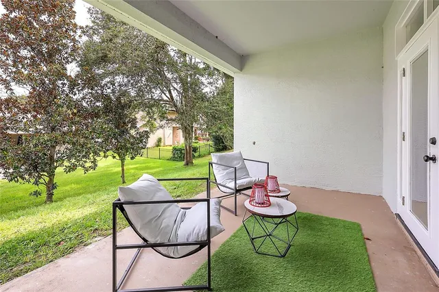 a backyard of a house with table and chairs