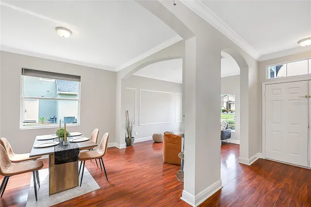 a view of a dining room with furniture and wooden floor