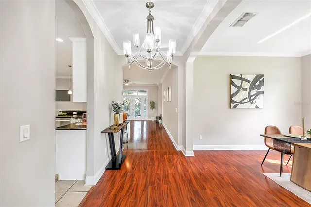a view of a dining room with furniture wooden floor and chandelier