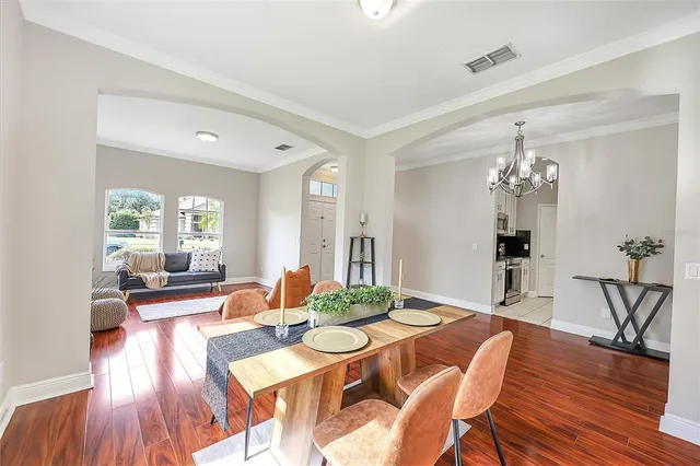 a view of a dining room with furniture window and wooden floor