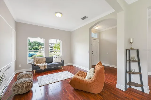 a living room with furniture and wooden floor