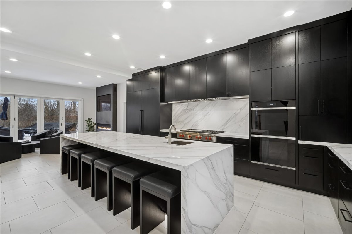 1630 Ridge Road Highland Park, IL 60035 - Photo 12 of 63 a kitchen with kitchen island a stove a table and chairs in it