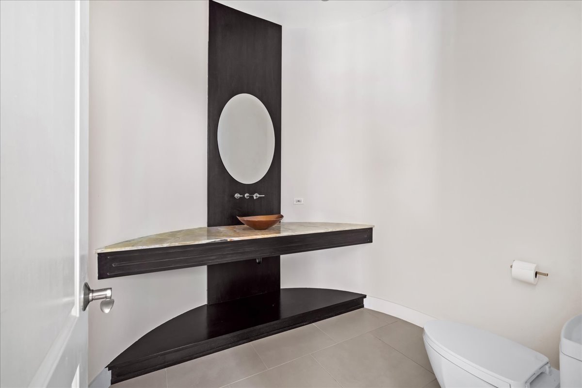 1630 Ridge Road Highland Park, IL 60035 - Photo 25 of 63 a room with a table and a mirror