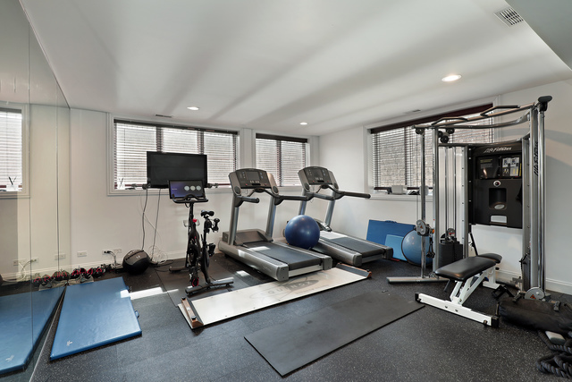 1630 Ridge Road Highland Park, IL 60035 - Photo 49 of 63 a room with gym equipment and a flat screen tv