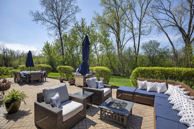 1630 Ridge Road Highland Park, IL 60035 - Photo 53 of 63 a view of a patio with couches potted plants and a large tree