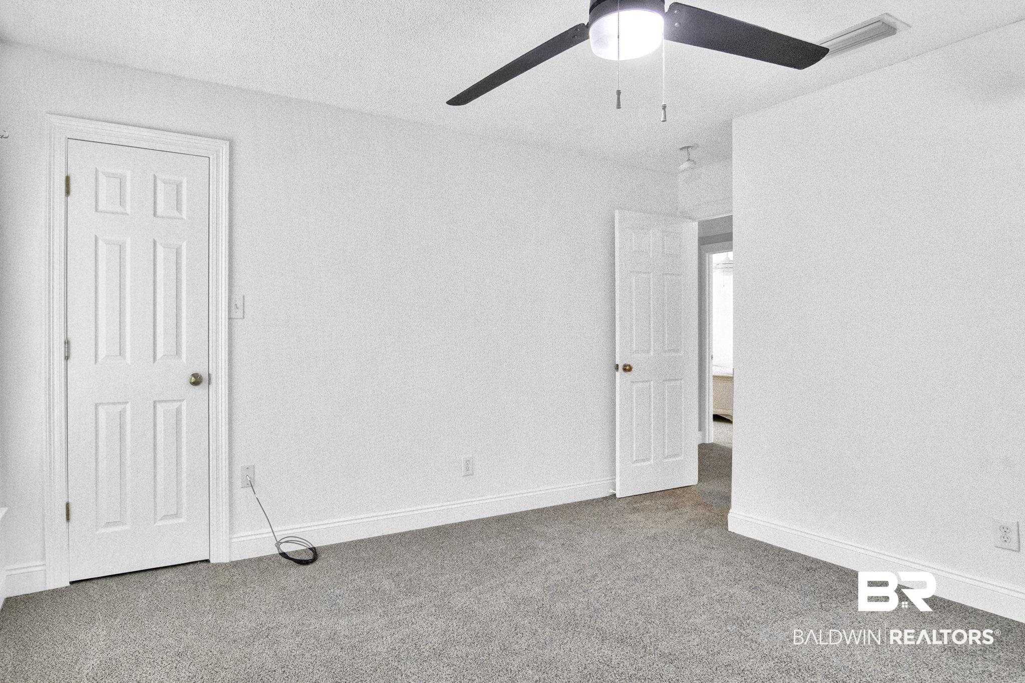 9002 Parliament Circle Daphne, AL 36526 - Photo 48 of 73 New Carpet, huge floored attic space in here, featuring ceiling fan