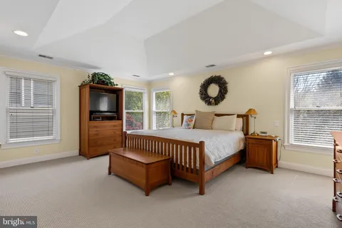 a spacious bedroom with a bed and window