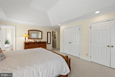 a room with a bed and dresser