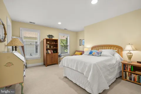 a bedroom with a large bed and a large window