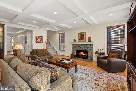 a living room with furniture a fireplace and a large window