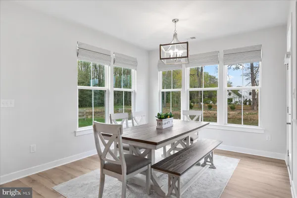 a view of a dining room with furniture window and outside view