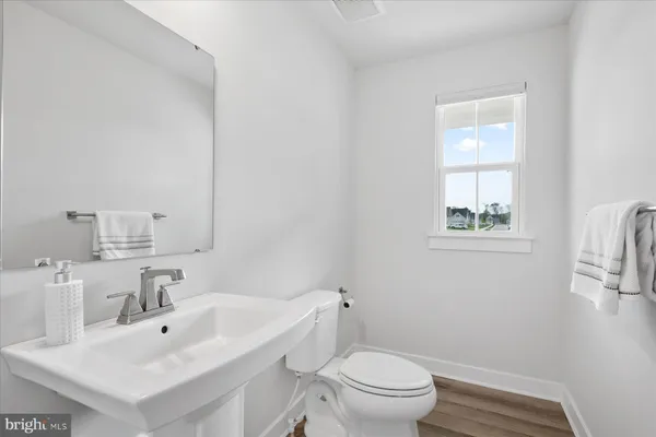 a bathroom with a sink mirror and toilet
