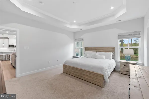 a bedroom with a bed and large window