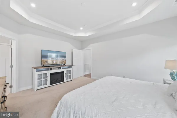 a bedroom with a bed and flat screen tv