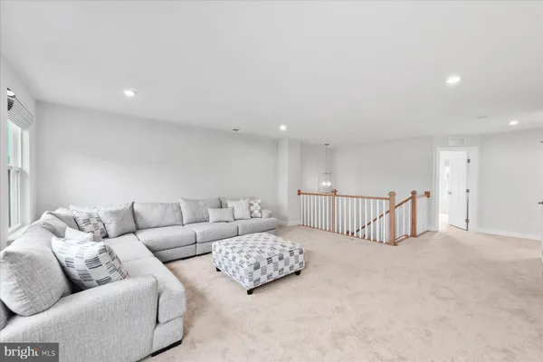 a living room with furniture and a ceiling fan