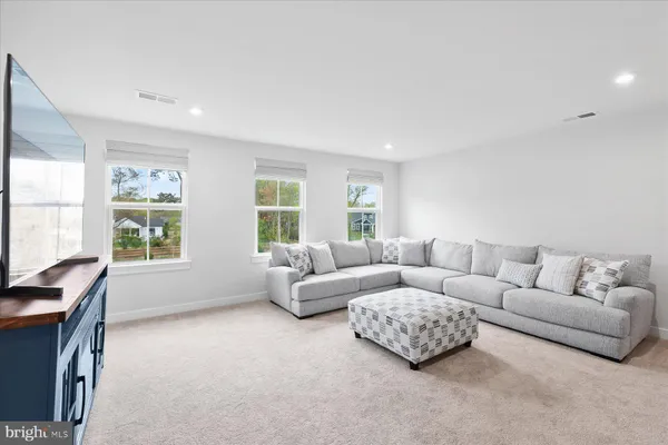 a living room with furniture and windows