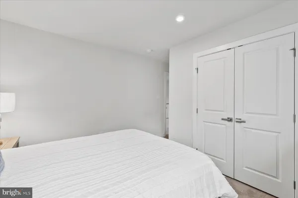 a bedroom with a bed and a closet