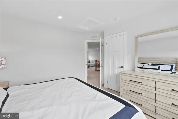a view of a bedroom with wooden floor