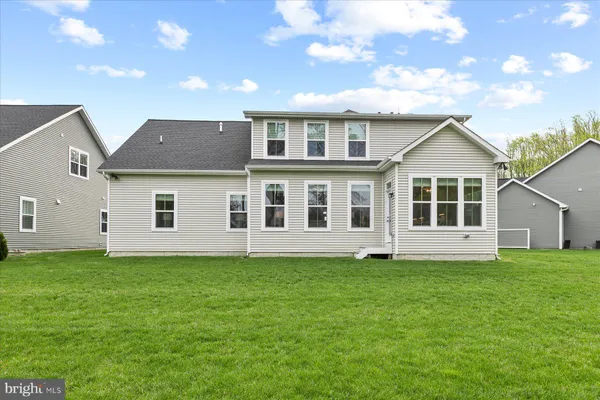 a big house with a big yard and large trees