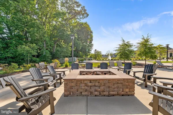 a view of backyard with seating space and trees