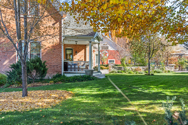 390 North 100 West Monroe, UT 84754 - Photo 21 of 167 Rear view of property featuring a yard, a porch, and brick siding