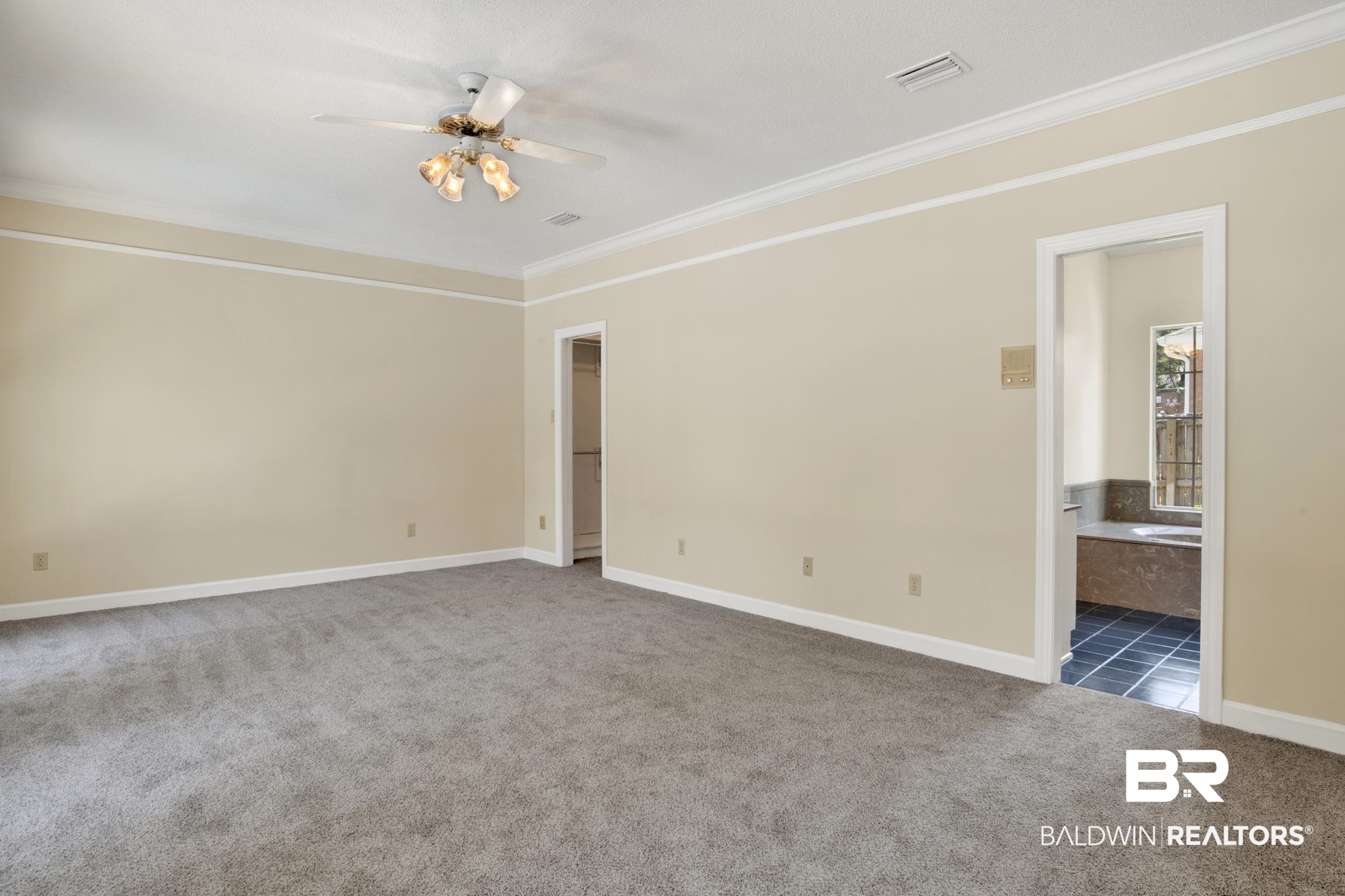 6805 Hunters Court Mobile, AL 36695 - Photo 19 of 37 Carpeted spare room featuring ornamental molding, a ceiling fan, and baseboards