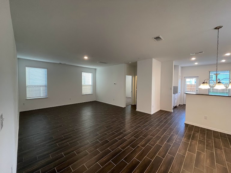 640 Pickrell Loop Georgetown, TX 78628 - Photo 8 of 36 an empty room with wooden floor and windows