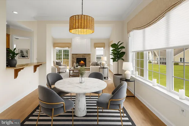 a dining room with furniture a chandelier and wooden floor