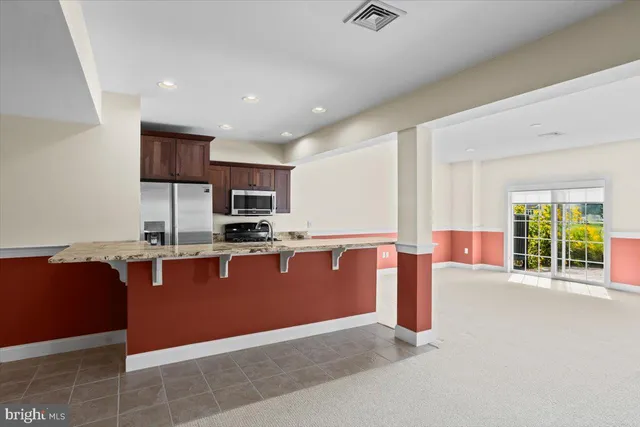 an empty room with windows and cabinet