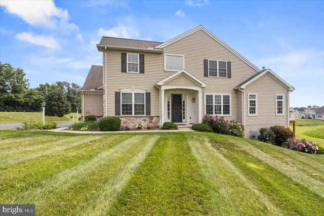 a front view of a house with swimming pool having outdoor seating