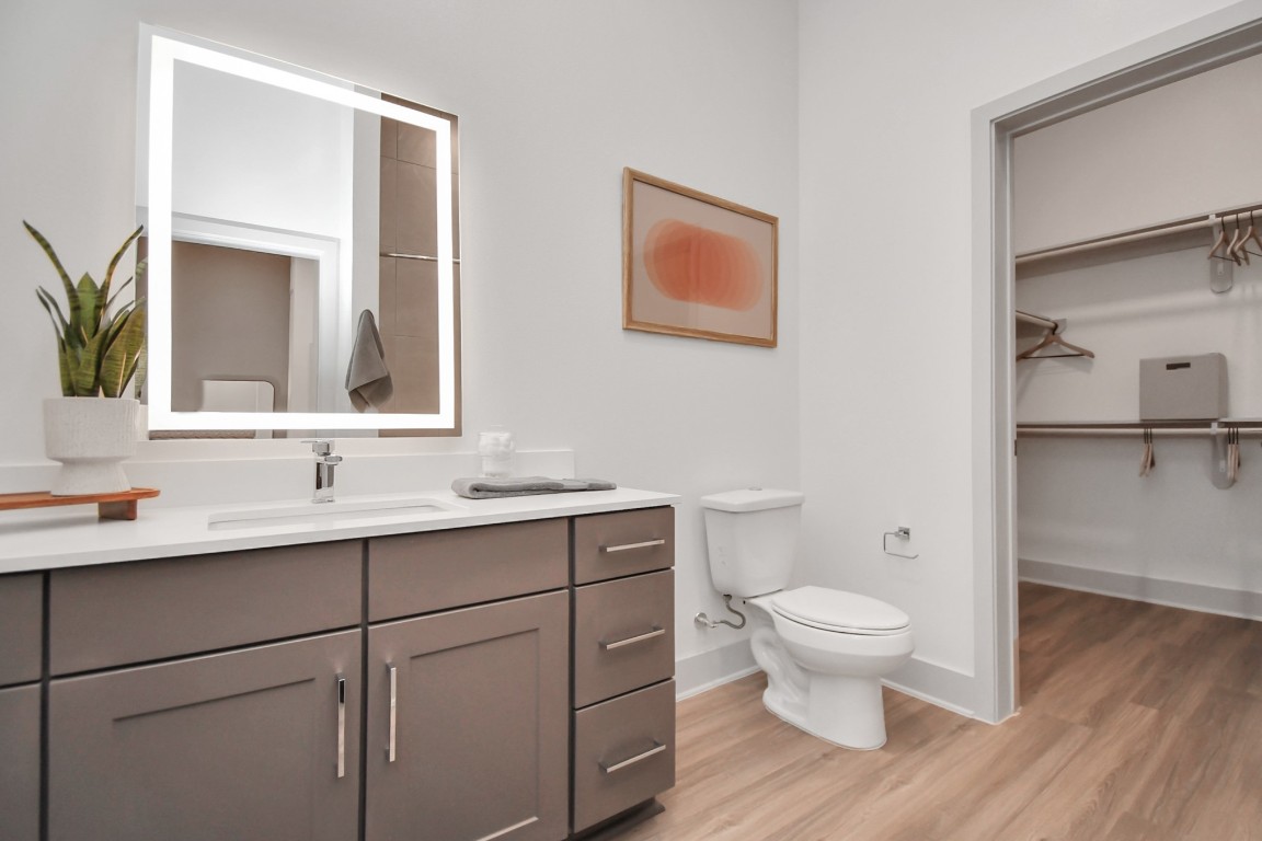 1617 Enid Street, Unit 318 Houston, TX 77009 - Photo 22 of 50 a bathroom with a toilet sink and mirror