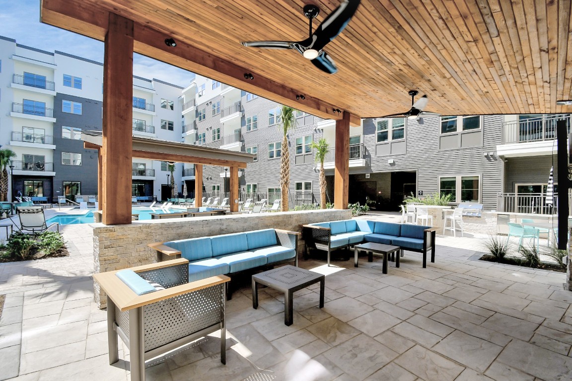 1617 Enid Street, Unit 318 Houston, TX 77009 - Photo 26 of 50 a outdoor space with patio the couches and a dining table with the potted plants