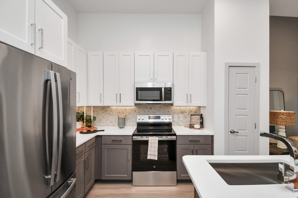 1617 Enid Street, Unit 318 Houston, TX 77009 - Photo 6 of 50 a kitchen with a refrigerator sink and stove