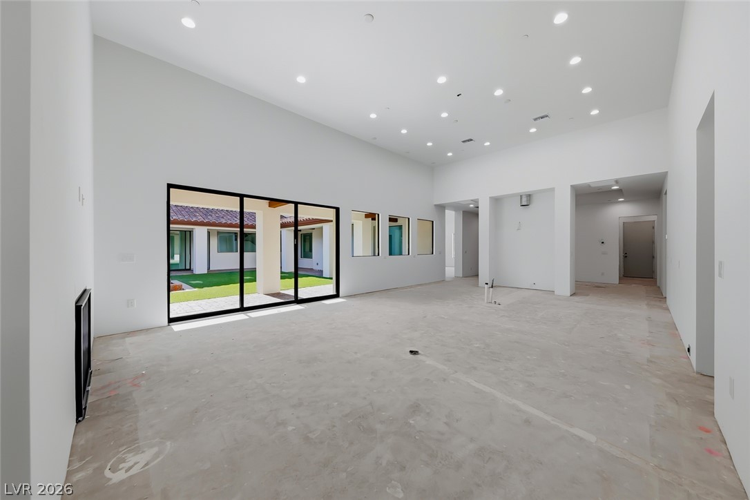 1140 Julie Road Henderson, NV 89002 - Photo 46 of 71 Floor-to-ceiling glass doors open to a pristine courtyard from this spacious, well-lit room.