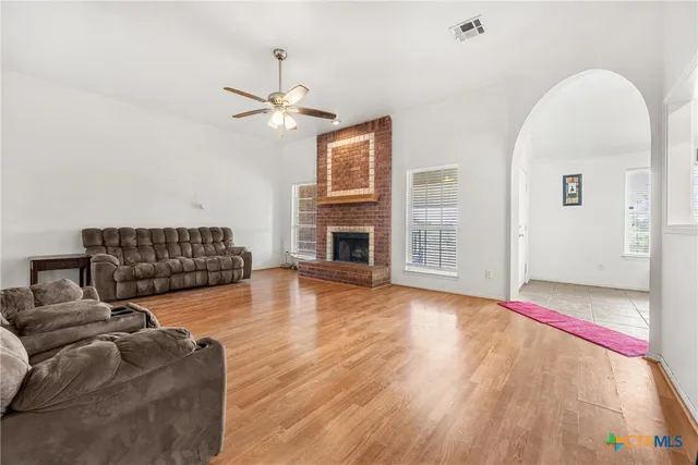a living room with furniture fireplace and flat screen tv