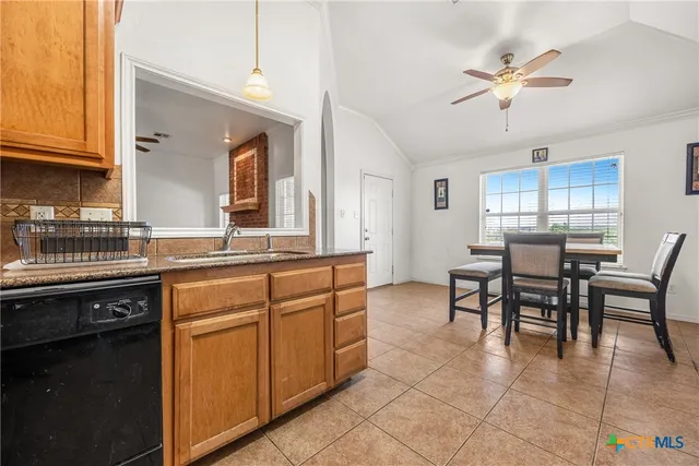 a kitchen with cabinets and chairs