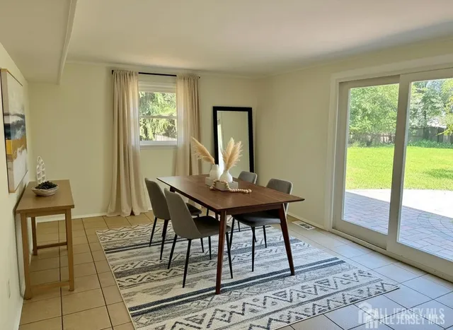 a view of a dining room with furniture and a window