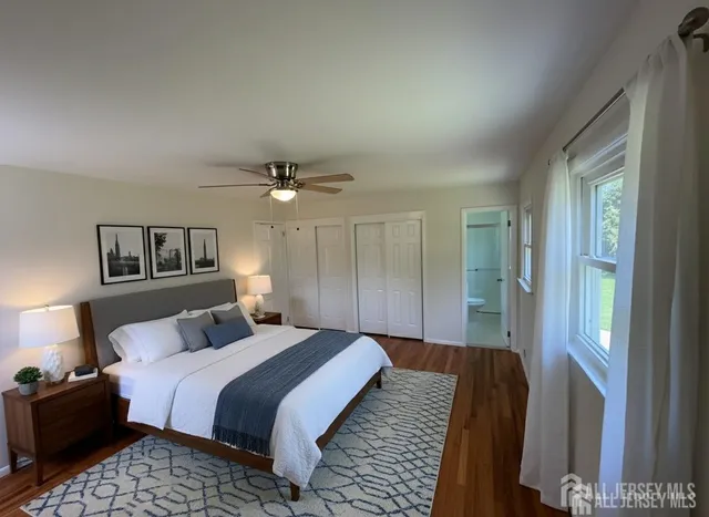 a bedroom with bed and a night stand